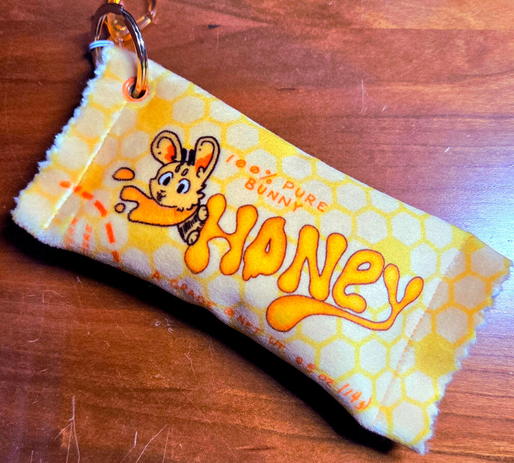 Plush Sauce Packet Keychains; Invented and 100% self-manufactured. Designed in Krita, Sublim print on mochi minky fused with silver foil leather, stuffed, sewn, and findings/hardware attaached in-house.