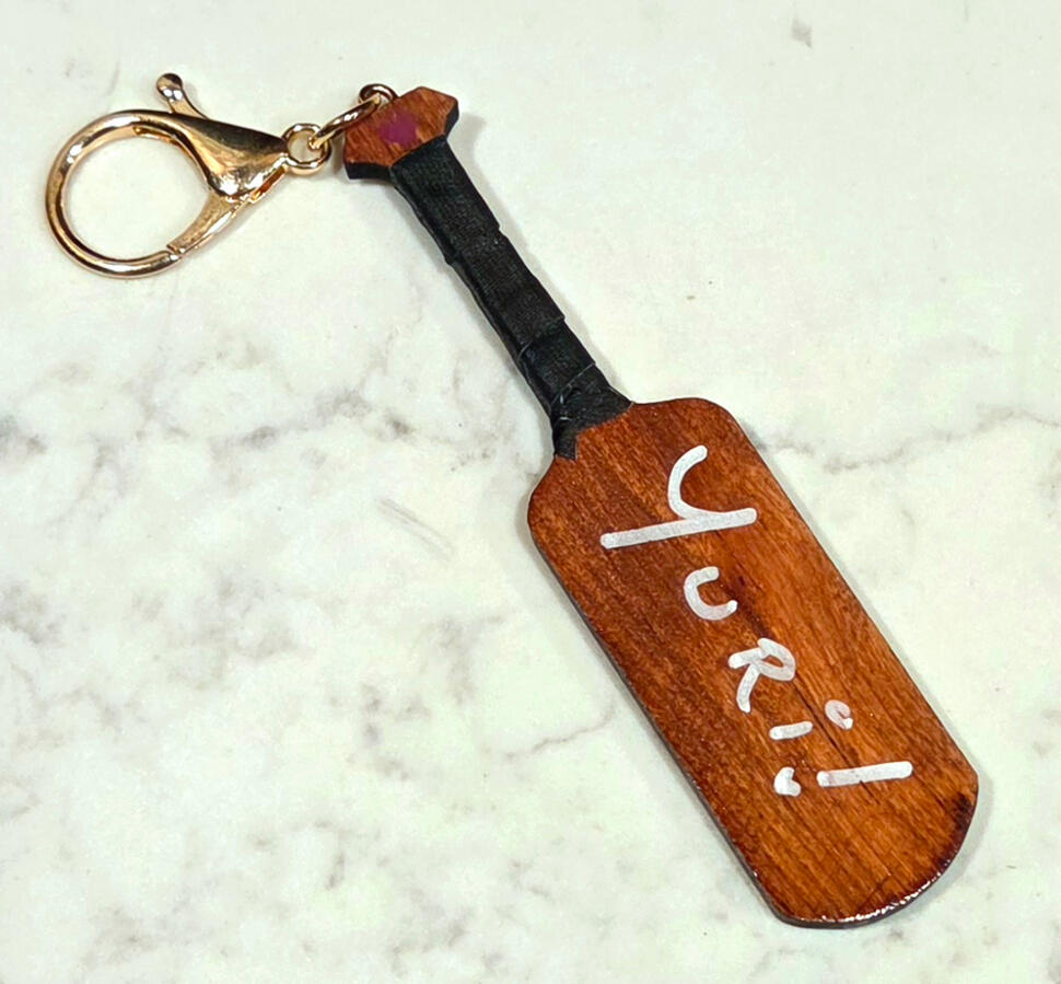 [V2] Wooden double sided Yaoi/Yuri Paddle Keychains; YURI SIDE; CNC cut solid Applewood, with an American Walnut Stain, hand-sized black handle tape, white acrylic hand lettering, UV-resistant topcoat polyurthane, and white gold hardware.