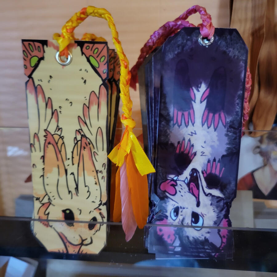opossum and skvader bookmarks, printed, glued, hot laminated, and assembled in-house